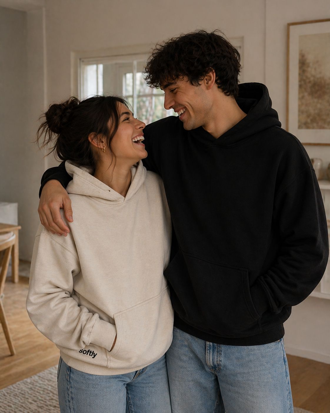 Couple wearing Softlly hoodies laughing